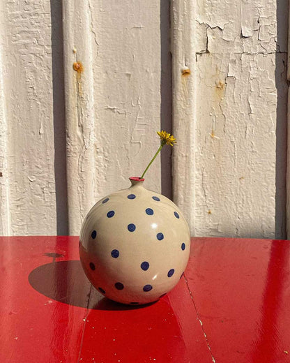 Handcrafted Spanish ceramic large vase with blue polka dots and red rim, featuring yellow wildflower on vibrant red surface