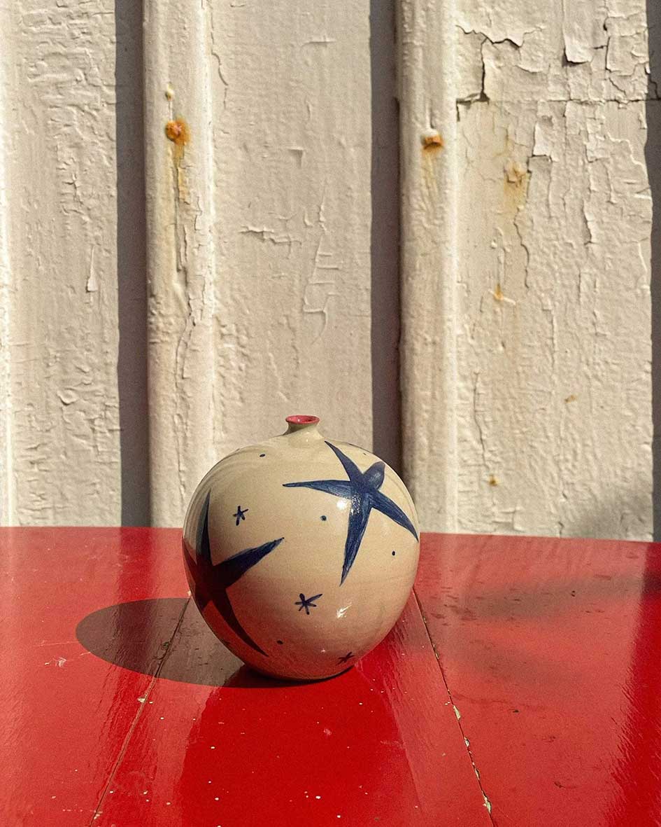 Handcrafted Spanish ceramic medium vase with blue star pattern, featuring red accent on vibrant red surface