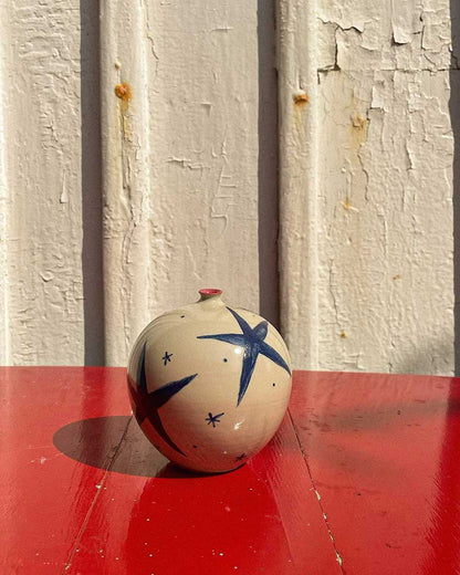 Handcrafted Spanish ceramic medium vase with blue star pattern, featuring red accent on vibrant red surface