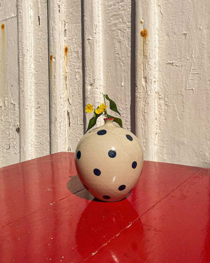 Handcrafted Spanish ceramic medium vase with blue polka dots, featuring yellow wildflowers on vibrant red surface